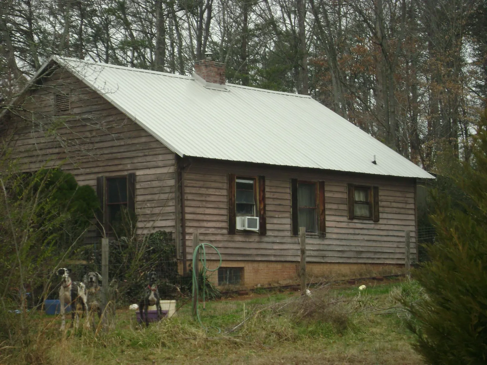White metal roof on an old wood sided farmhouse, from a Metal Roof Installation job in Summersville